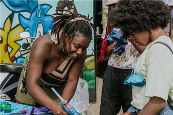 Youth worker and two young people are creating