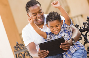 image of happy father and son using an iPad or tablet