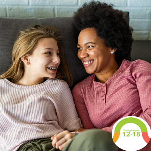 image of parent and a teenager chatting on the sofa